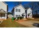 Street view of a well-maintained home featuring a symmetrical facade, tidy landscaping, and inviting curb appeal at 1008 Beaugard Dr, Charlotte, NC 28208