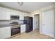 Updated kitchen featuring stainless steel appliances, modern finishes, and ample cabinet space at 1008 Beaugard Dr, Charlotte, NC 28208