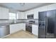 Modern kitchen with stainless steel appliances and sleek white cabinetry, offering both style and functionality at 1008 Beaugard Dr, Charlotte, NC 28208