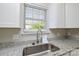 Well lit, renovated sink with stainless steel faucet fixtures and granite countertops at 1008 Beaugard Dr, Charlotte, NC 28208