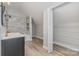 Well-lit bathroom featuring modern fixtures, granite countertops, a tub, and a closet at 102 S Liberty St, Gastonia, NC 28052