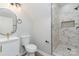 Bright bathroom showcasing a tiled shower, white vanity, and modern fixtures, blending clean design at 102 S Liberty St, Gastonia, NC 28052