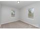 Inviting bedroom with two windows offering natural light and neutral carpet, creating a cozy atmosphere at 102 S Liberty St, Gastonia, NC 28052