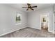 Neutral bedroom with a ceiling fan, window, and access to an attached bathroom at 102 S Liberty St, Gastonia, NC 28052