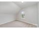 Minimalist bedroom with neutral carpet, a small window, and ample natural light at 102 S Liberty St, Gastonia, NC 28052