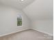 Bedroom features a window with a view of trees and a sloped ceiling at 102 S Liberty St, Gastonia, NC 28052