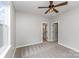 Bright bedroom featuring a ceiling fan and two entryways to the bathroom and closet at 102 S Liberty St, Gastonia, NC 28052