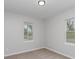 Bedroom featuring two windows overlooking the neighborhood at 102 S Liberty St, Gastonia, NC 28052