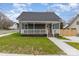 Charming home with a welcoming front porch and well-maintained lawn at 102 S Liberty St, Gastonia, NC 28052