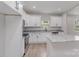 Contemporary kitchen with white cabinetry, granite counters, stainless appliances, and island at 102 S Liberty St, Gastonia, NC 28052