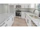 Modern kitchen featuring white cabinets, stainless steel appliances, and granite countertops at 102 S Liberty St, Gastonia, NC 28052