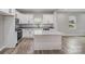 Elegant kitchen featuring white cabinetry, granite countertops, and stainless steel appliances at 102 S Liberty St, Gastonia, NC 28052