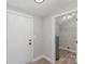 Mud room features a door, wood-look floors and an entrance to what appears to be a utility room at 102 S Liberty St, Gastonia, NC 28052