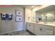 Bathroom with tiled flooring, double sink vanity, and a glass door shower at 107 Windstone Common Ln, Mooresville, NC 28117