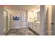 Bathroom with tiled flooring, double sink vanity, and a glass door shower at 107 Windstone Common Ln, Mooresville, NC 28117