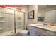 Bathroom featuring a walk-in shower with sliding glass doors and white vanity at 107 Windstone Common Ln, Mooresville, NC 28117