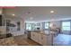 Open concept kitchen and dining room featuring an island with granite countertops and stainless steel appliances at 107 Windstone Common Ln, Mooresville, NC 28117