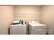 Bright laundry room with white appliances and convenient overhead shelving at 107 Windstone Common Ln, Mooresville, NC 28117