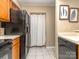 Practical kitchen with a black refrigerator and sleek black dishwasher for modern living at 10901 Carmel Crossing Rd, Charlotte, NC 28226