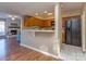 Open-concept kitchen with wood cabinets and black appliances connected to the living room at 10901 Carmel Crossing Rd, Charlotte, NC 28226