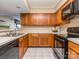 Well-lit kitchen features wood cabinets, modern appliances, and neutral countertops at 10901 Carmel Crossing Rd, Charlotte, NC 28226