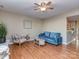 Cozy living room with hardwood floors, ceiling fan, and comfortable seating at 10901 Carmel Crossing Rd, Charlotte, NC 28226