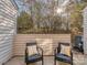 Outdoor patio with two chairs and cushions overlooking a serene yard with privacy fence at 10901 Carmel Crossing Rd, Charlotte, NC 28226