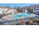 Community pool surrounded by a black fence and deck chairs, adjacent to condo buildings at 10901 Carmel Crossing Rd, Charlotte, NC 28226