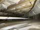 Crawlspace view highlights a vapor barrier, pipes, insulation, and ductwork promoting a dry and efficient foundation at 1232 Bilmark Ave, Charlotte, NC 28213