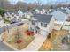 Aerial view of a neighborhood street and the home with a driveway and manicured yard at 1301 Waylon Ave, Gastonia, NC 28054