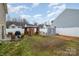 Fenced backyard with a gazebo, storage shed, patio with a grill, and mature trees at 1301 Waylon Ave, Gastonia, NC 28054