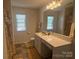 Bathroom features vanity, toilet, and shower with neutral tiled floors at 1301 Waylon Ave, Gastonia, NC 28054