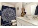 Bathroom with blue patterned shower curtain, modern vanity, and decorative accessories at 1301 Waylon Ave, Gastonia, NC 28054