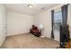 Minimalist bedroom with neutral carpet, a window, and a few decorative items at 1301 Waylon Ave, Gastonia, NC 28054