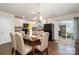 The dining area has hardwood floors, a modern chandelier, and access to a backyard patio at 1301 Waylon Ave, Gastonia, NC 28054