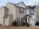 Two story home with neutral siding, stone accents, dark shutters, and a one car garage at 1301 Waylon Ave, Gastonia, NC 28054