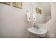 Charming half bathroom with pedestal sink, mirror, and neutral decor at 1301 Waylon Ave, Gastonia, NC 28054