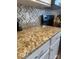 Close-up of granite countertops and stylish backsplash in the kitchen at 1301 Waylon Ave, Gastonia, NC 28054