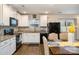 Modern kitchen with white cabinetry, granite countertops, and stainless steel appliances open to dining area at 1301 Waylon Ave, Gastonia, NC 28054