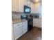 Well-lit kitchen features white cabinets, granite countertops, and a black microwave at 1301 Waylon Ave, Gastonia, NC 28054