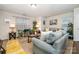 Bright living room with yellow accents and various plants creating a comfortable and inviting atmosphere at 1301 Waylon Ave, Gastonia, NC 28054