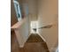 Carpeted staircase with white railing leading to the lower level, with natural light at 1301 Waylon Ave, Gastonia, NC 28054