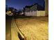 Landscaped yard with white fencing at dusk, creating a private and inviting space at 1301 Waylon Ave, Gastonia, NC 28054