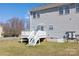 A backyard featuring a deck with stairs leading down to the lawn perfect for enjoying your home at 136 Ridge Bluff Rd, Mooresville, NC 28115