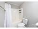 Modern bathroom with white shower curtain and built in shelves in shower at 136 Ridge Bluff Rd, Mooresville, NC 28115