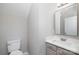 Modern half bathroom features gray vanity, white marble countertop, and streamlined fixtures at 136 Ridge Bluff Rd, Mooresville, NC 28115