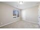 Neutral bedroom features carpet flooring, a double window, and white trim at 136 Ridge Bluff Rd, Mooresville, NC 28115