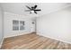 Bright living room featuring sleek floors, a ceiling fan, and ample natural light at 136 Ridge Bluff Rd, Mooresville, NC 28115