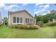 Outdoor patio featuring seating, a grill, and lush landscaping surrounded by green lawn at 14309 Stonewater Ct, Fort Mill, SC 29707
