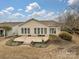 The backyard has a patio area and a view of the home's back facade with many windows at 14309 Stonewater Ct, Fort Mill, SC 29707